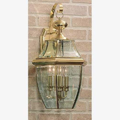 Quoizel Newbury Outdoor Wall Lantern, 23 Inch 3-Light Polished Brass Wall Sconce, French Country Exterior Wall Lantern Fixture, E12 Base, Clear Glass, Outside Lights for Patio, Porch, Garage or Yard