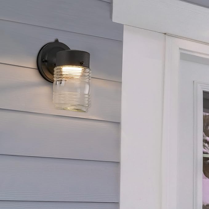 Maxxima Outdoor Wall Lantern Light Fixture, Enclosed Clear Ribbed Glass Jelly Jar Exterior Light, Black Finish, Dusk to Dawn Sensor, 800 Lumens, Photocell Sensor, 3000K Warm White