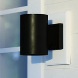 VAXCEL Chiasso Modern Outdoor Porch Light, 5" W x 7.25" H Black Cylinder Wall Sconce, Waterproof Dark Sky Wall | Lumora