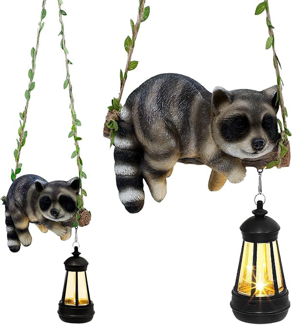Solar Lighted Garden Outdoor Statue, 20.1" H Hanging Swing Lying with A Sleeping Raccoon and A LED Lantern, Resin | Lumora