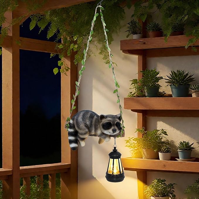 Solar Lighted Garden Outdoor Statue, 20.1" H Hanging Swing Lying with A Sleeping Raccoon and A LED Lantern, Resin | Lumora