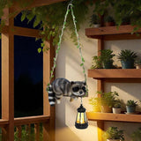 Solar Lighted Garden Outdoor Statue, 20.1" H Hanging Swing Lying with A Sleeping Raccoon and A LED Lantern, Resin | Lumora
