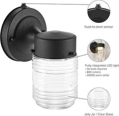 Maxxima Outdoor Wall Lantern Light Fixture, Enclosed Clear Ribbed Glass Jelly Jar Exterior Light, Black Finish, Dusk to Dawn Sensor, 800 Lumens, Photocell Sensor, 3000K Warm White
