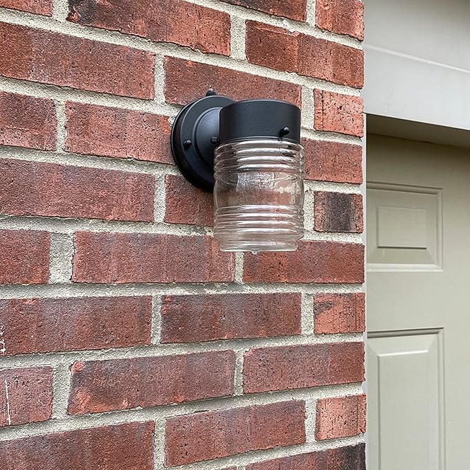 Maxxima Outdoor Wall Lantern Light Fixture, Enclosed Clear Ribbed Glass Jelly Jar Exterior Light, Black Finish, Dusk to Dawn Sensor, 800 Lumens, Photocell Sensor, 3000K Warm White